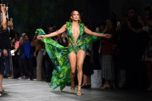 Jennifer Lopez walking the runway in her iconic green Versace dress.