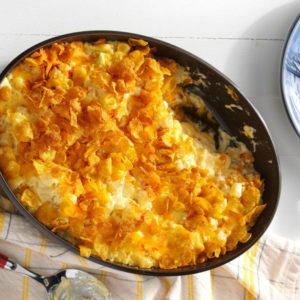 Cheesy potato casserole, topped with corn flakes and ready for serving in a hot bowl