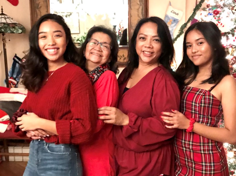 Multiple generations of the Lorenzo family gather for a picture in Christmas garb