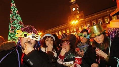 Spanish men and women gathered in La Puerta del Sol to eat the 12 lucky grapes at the stroke of midnight