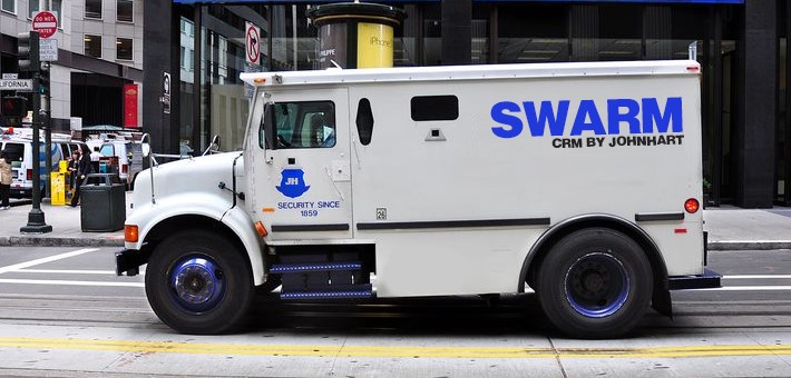 Brinks truck with the words Swarm, CRM by JohnHart swapped out for the logo