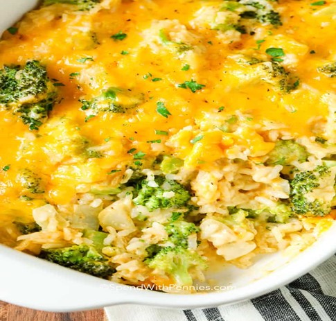 white porcelain  bowl with cheesy rice and broccoli casserole