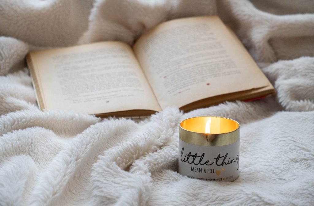a candle next to a book