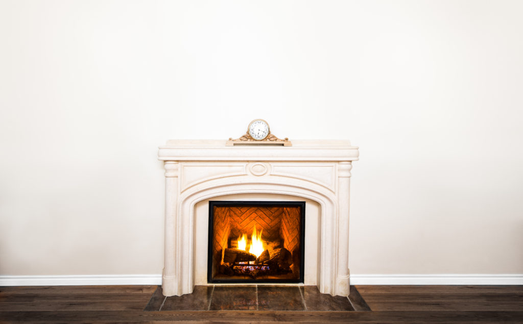 fireplace with white mantle and clock
