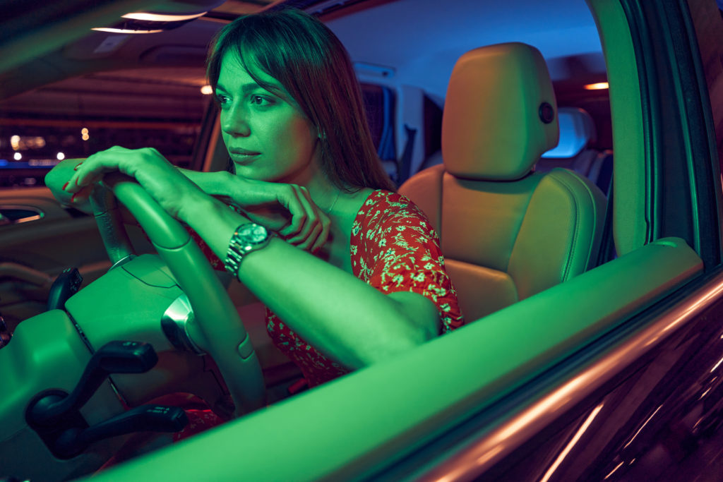 Girl sitting behind the steering wheel of a car
