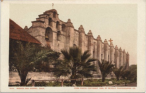 postcard depicting early transplants of los angeles palm trees around a San Gabriel mission