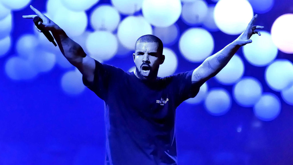 Drake in concert with blue light in the background