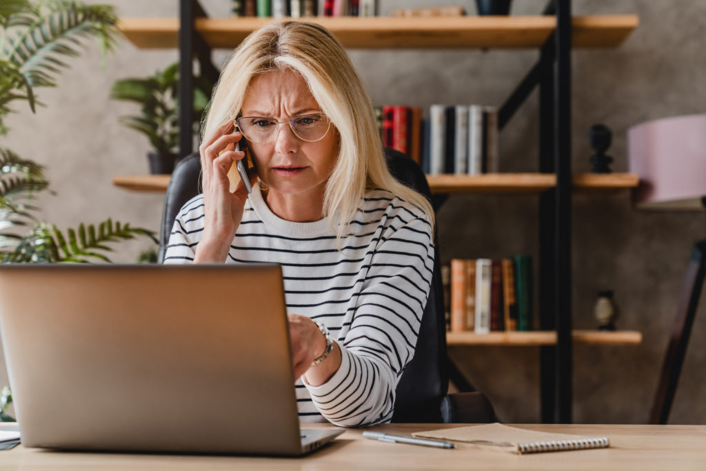 woman on phone with home insurance california broker over lapsed coverage