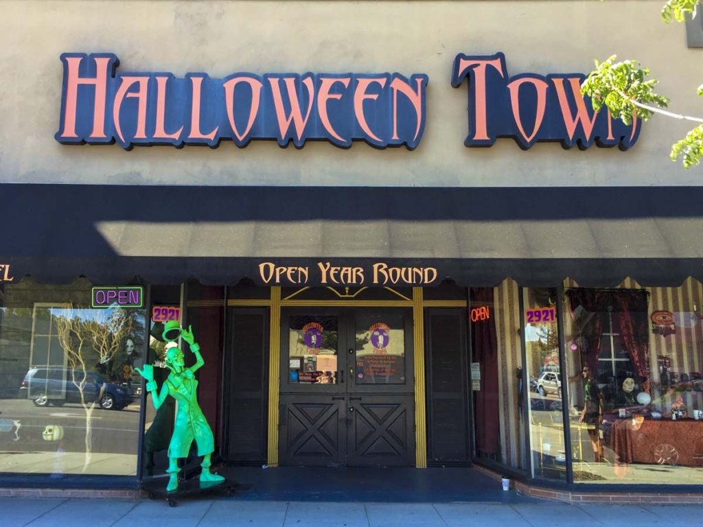 Street view of Halloween Town costume shop in Burbank with sign reading open year round. 